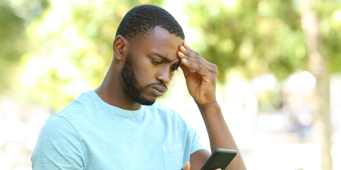 a man wary looking at his phone